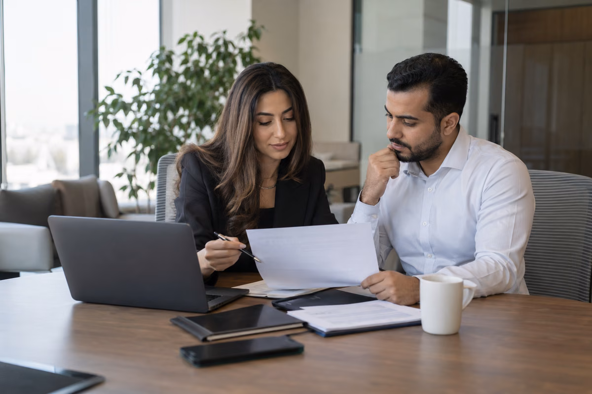Finance professionals reviewing monthly payroll records together