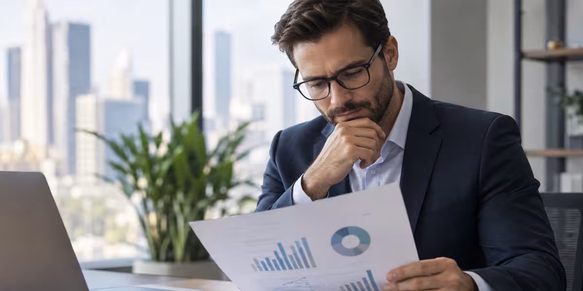 Business professional reviewing financial charts at a desk