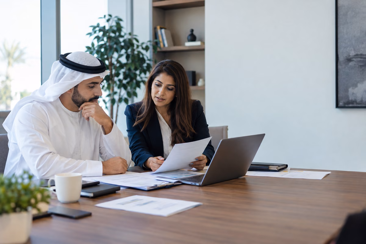 Business owner and tax adviser reviewing records for a VAT deregistration decision