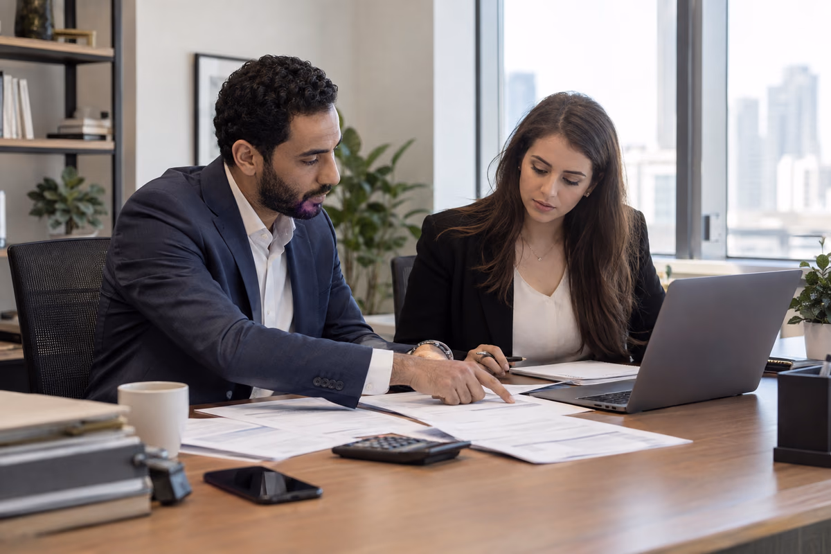 Finance professionals checking invoices and records together before correcting a VAT return